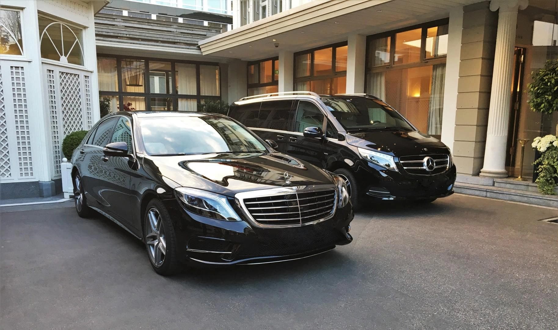 Chauffeur closing the rear door of a Mercedes E-Class